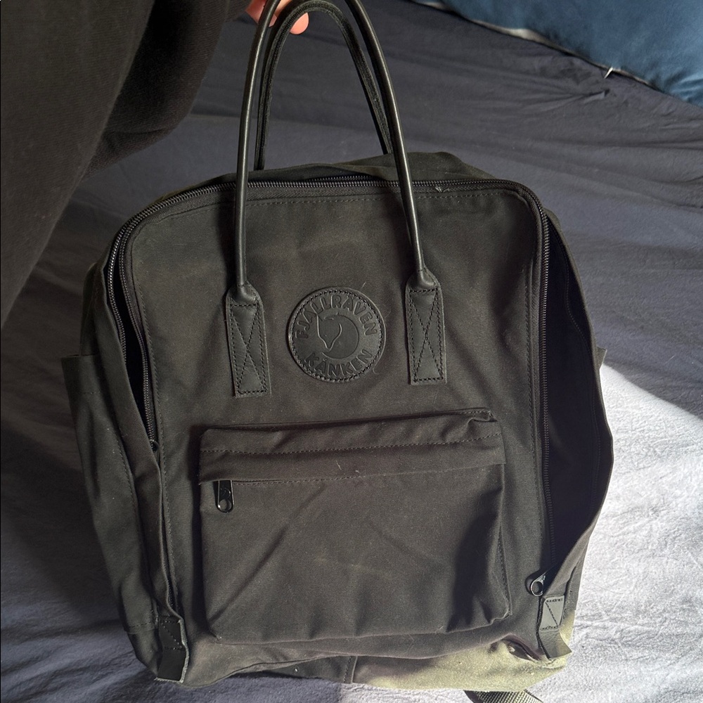 Fjallraven Kanken black backpack with leather logo patch and leather handles